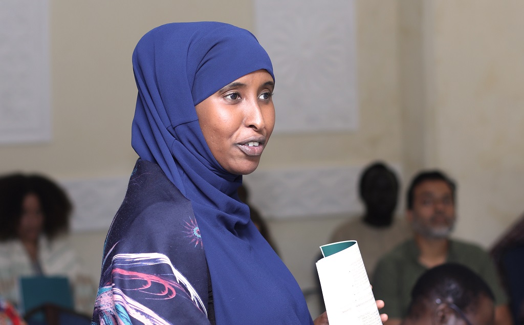 A woman with a blue head scarf.