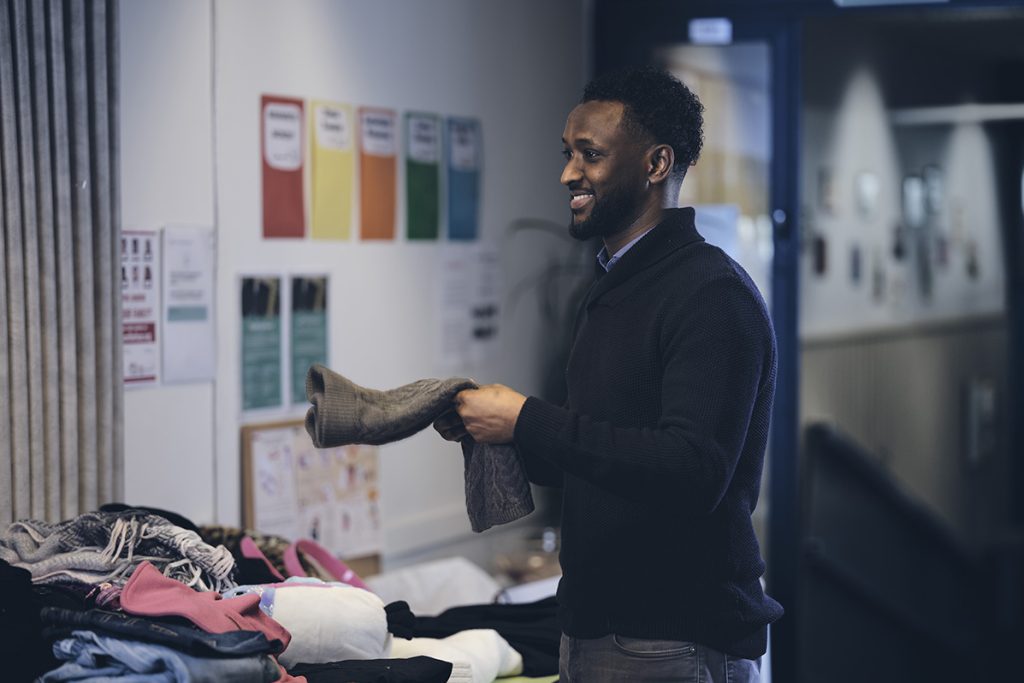 A man is sorting clothes.