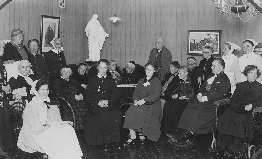 Joukko naisia istuu ja seisoo ryhmänä.